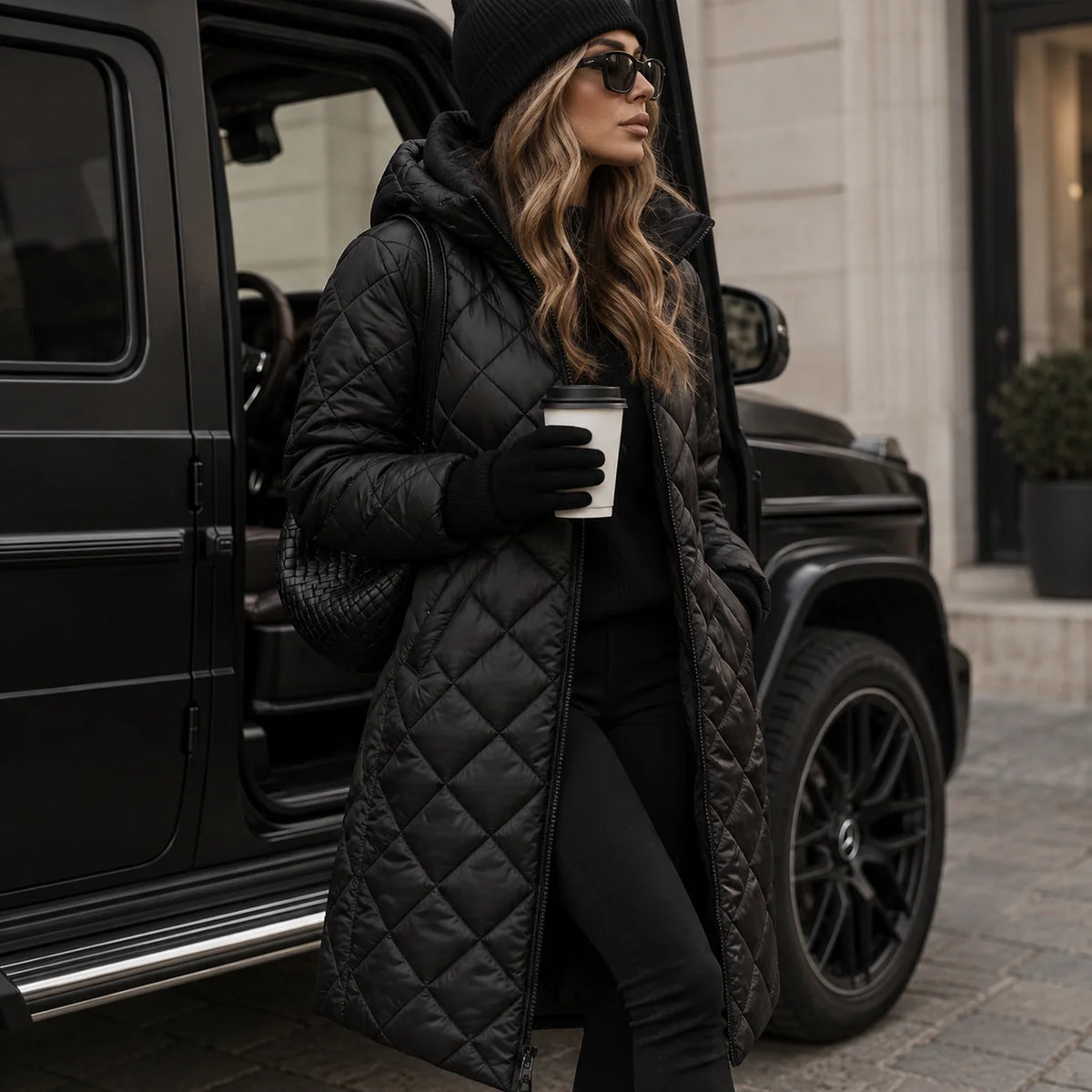 Black Women's Long Quilted Puffer Coat with Hooded Design & Tailored Fit - Front Pose Vehicle