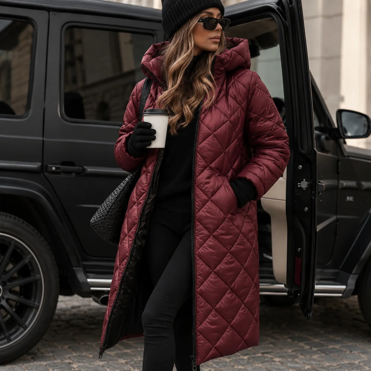 Red Women's Long Quilted Puffer Coat with Hooded Design & Tailored Fit - Front Pose Doorway