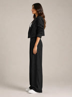 Black Women's Pinstripe Two-Piece Suit with Cropped Blazer & Relaxed Wide-Leg Pants — Beatrice - Side Profile