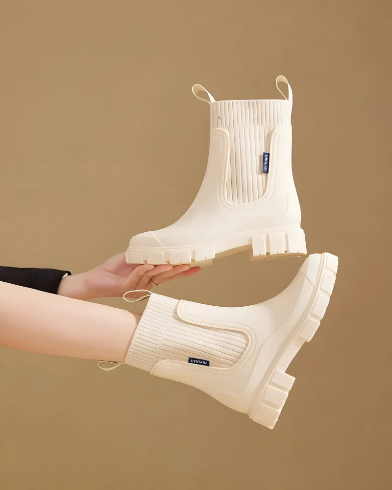 Beige Women's Waterproof Chelsea Boots with Knit Ankle Cuff & Pull Tabs — Siobhan - Held Up Pair Detail