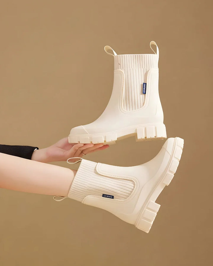Beige Women's Waterproof Chelsea Boots with Knit Ankle Cuff & Pull Tabs — Siobhan - Held Up Pair Detail