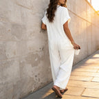 White Women's Wide Leg Jumpsuit in Crinkle Linen with Button-Front Collar — Halle - Back Leaning Wall