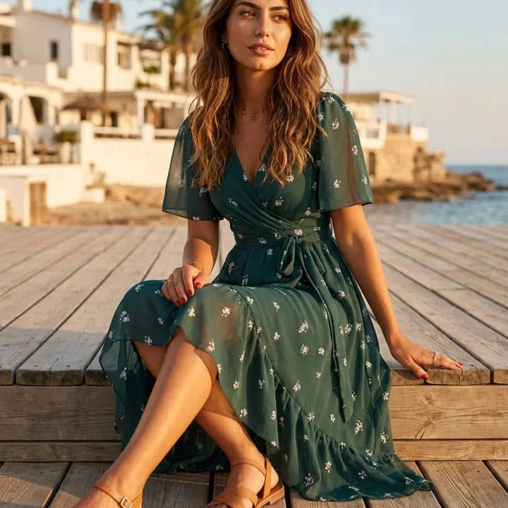 Green Women's Fall Wedding Guest Dress in Floral Wrap Style with Flutter Sleeves — Wren - Seated Outdoor Dock